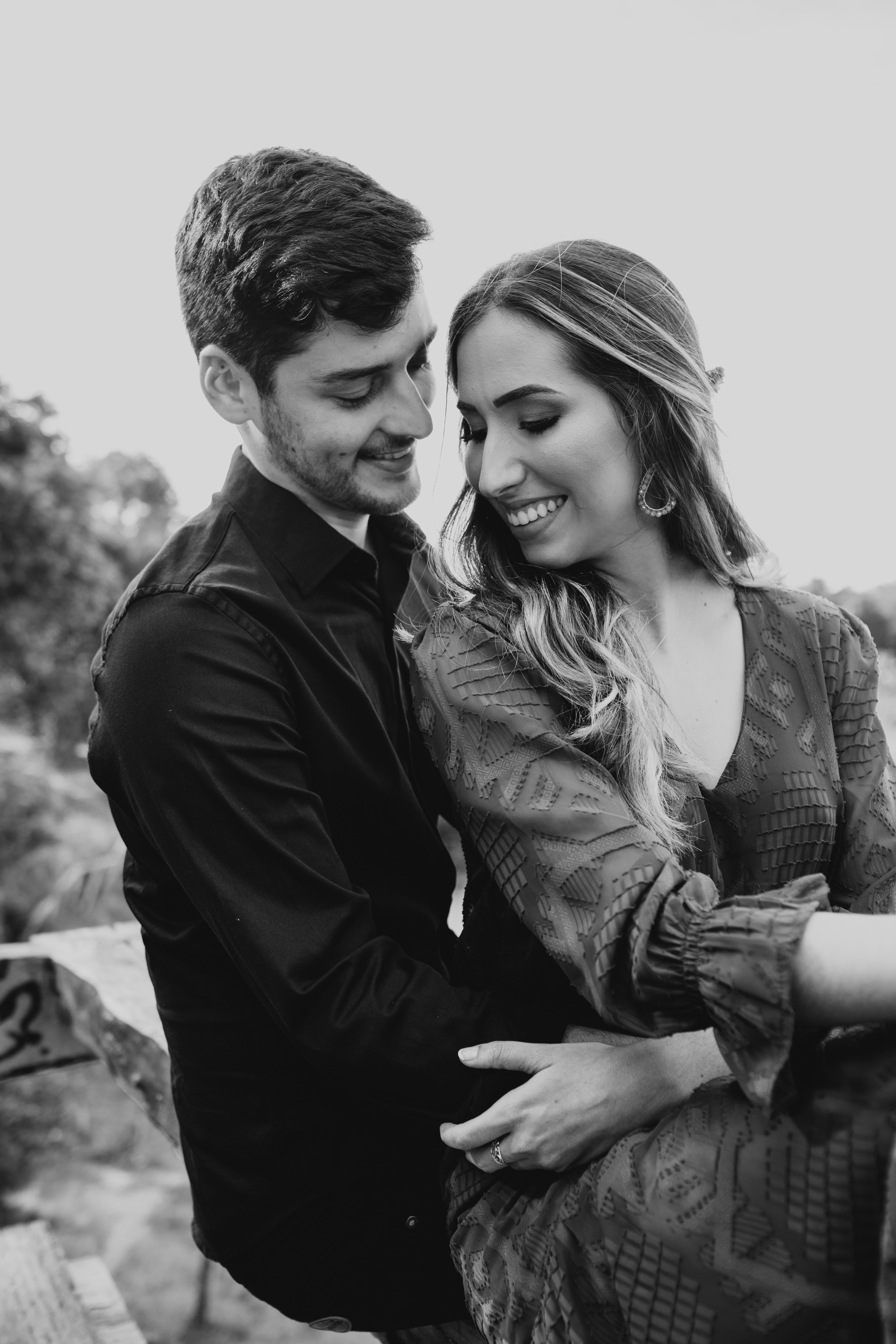 man in black suit jacket kissing woman in gray scale